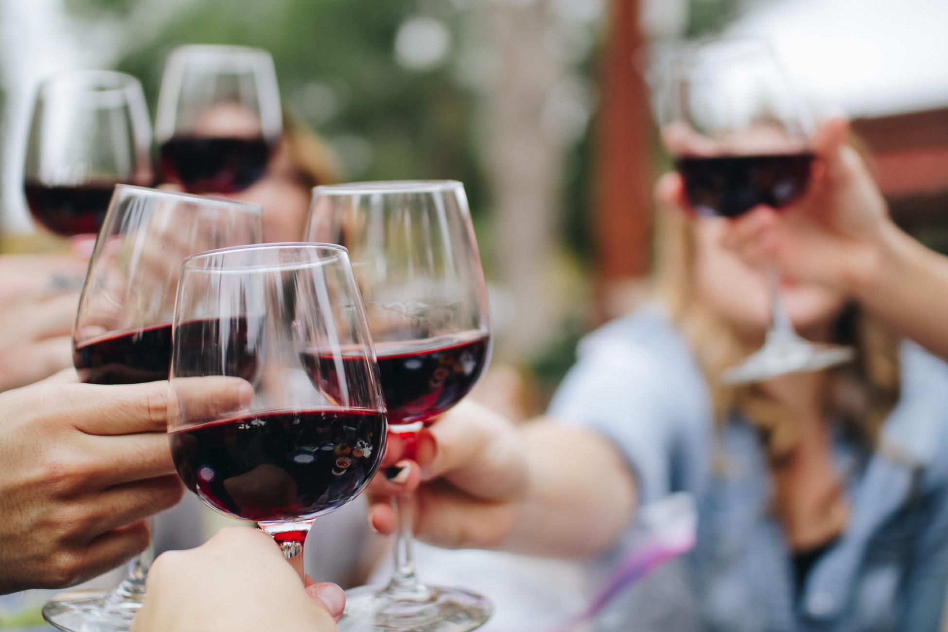 Friends toasting with glasses of red wine