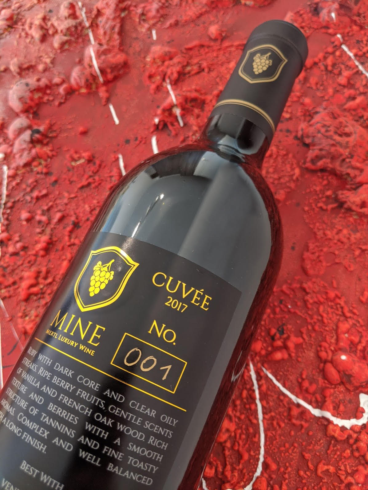Gold foil back label of the MINE bottle