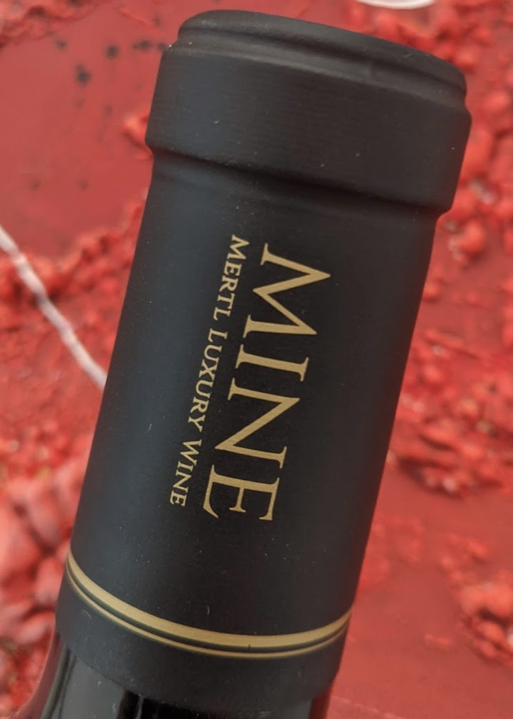 Top gold embossing of the MINE grapes